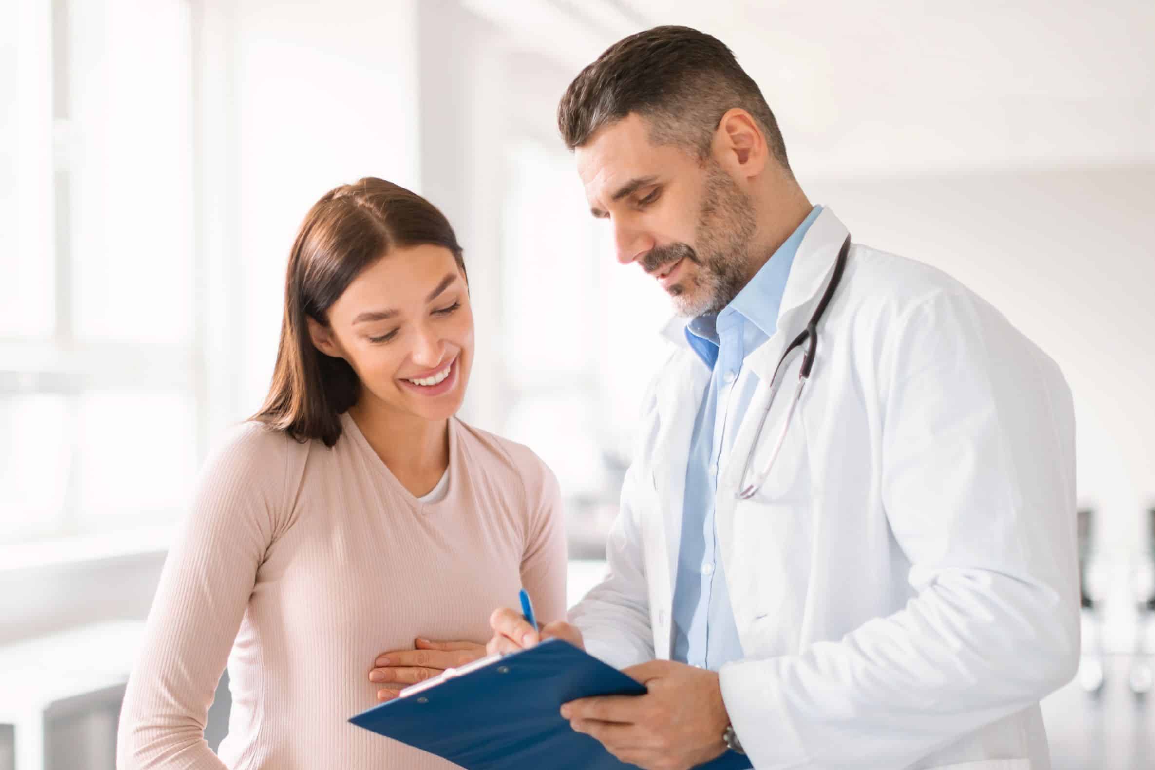 pregnant woman speaking with a doctor